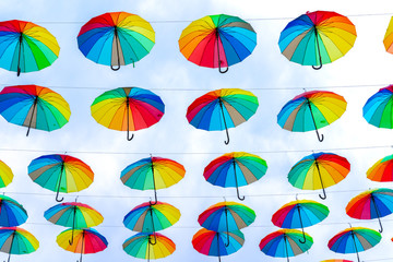 Fototapeta na wymiar City decorations. Many different umbrellas