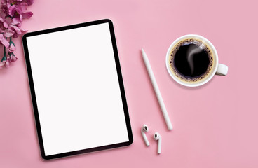 Modern tablet, white wireless headphones with coffee on a pink background. © Hazal
