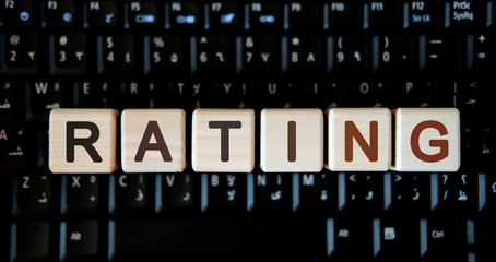 Fototapeta premium Rating - concept text on wooden cubes on background black keyboard