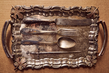 Antique cutlery. table setting in vintage style. Antique fork, old knife, spoon. Space for recording, antique dishes.