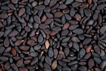 Background of black sesame seeds. Top view. Macro photography.