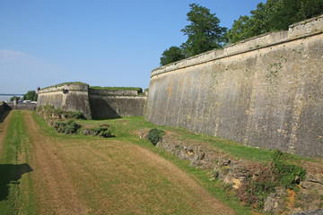 Fototapeta na wymiar Historic city walls around the moat and fortifications to the citadel of Blaye, Gironde department in Nouvelle- Aquitaine in southwestern France.