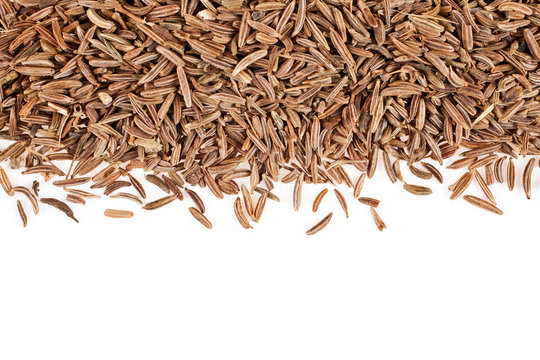 Heap of caraway seeds isolated on a white background. Macro photography.