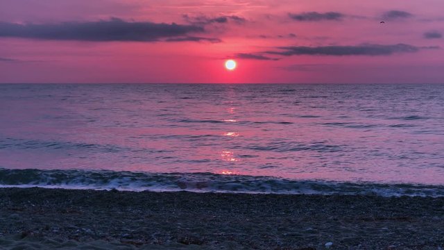 Sunrise over the calm sea, blurred reflected.  Yellow sun rises above sea, solar path on water. Sunlight and sun ray over sea reflect on water surface. Golden light, orange and gold blue sky, sea pano