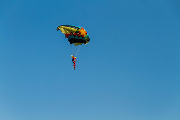 Artistic landing on the ground using a colorful parachute
