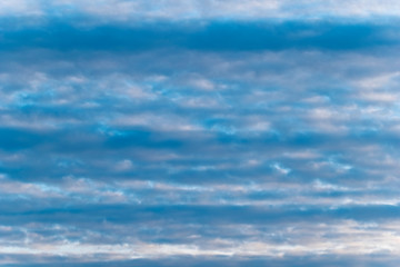 Clouds in the blue sky arranged in equal lines