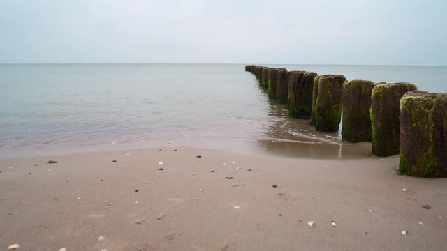 wooden blockade against the waves over the beautiful sea