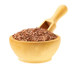 flaxseed in a wooden bowl with a scoop isolated on a white background.