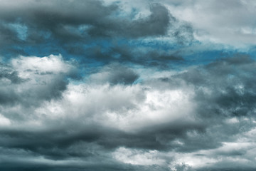 Naklejka na ściany i meble Dramatic multi-tones blue sky and fluffy white and gray clouds background.