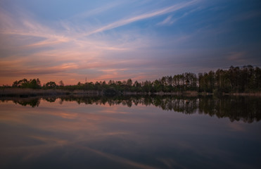 Sunset evening view on Sukhovilske Lake and forest in Sukhovolia, Rudno. Lviv district, Ukraine. May 2020