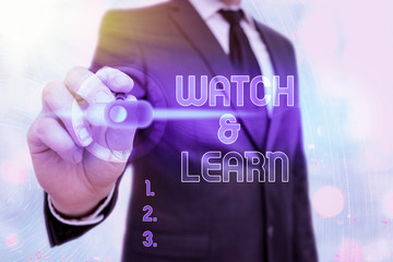 Writing note showing Watch And Learn. Business concept for demonstrating an action or ideas of how...
