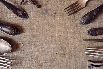 Antique cutlery. table setting in vintage style. Antique fork, old knife, spoon. Space for recording, antique dishes.