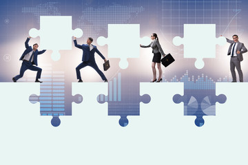 Businessman in teamwork concept with jigsaw puzzle