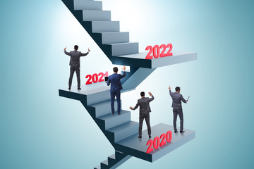 Businessman climbing stairs on yearly basis