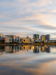 Morning view of building skyline at Wentworth Point, Sydney, Australia with reflection on the water.