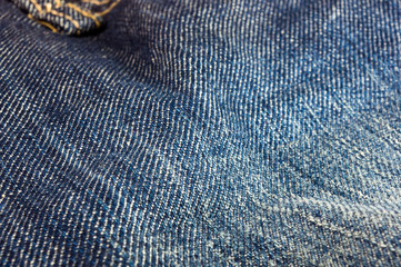clothing items blue stonewashed faded jeans cotton fabric texture with seams, clasps, buttons and...