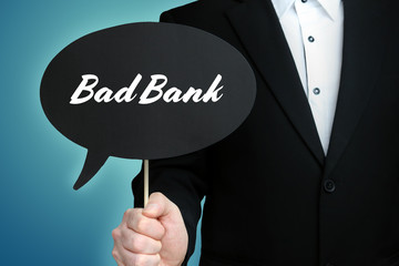 Bad Bank. Lawyer (Man) holds the sign of a speech bubble in his hand. Text on the label. Symbol of law, justice, judgement