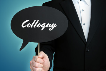Colloquy. Lawyer (Man) holds the sign of a speech bubble in his hand. Text on the label. Symbol of...