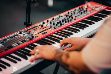 hands of a man playing piano