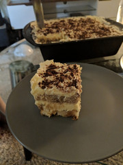 Homemade piece of tiramisu cake on a plate