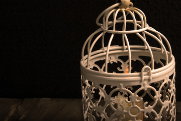 Close up shot of candle lantern on a rustic wooden table