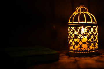 Close up shot of candle lantern on a rustic wooden table