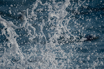 A zoomed in shot of splashed sea water broken down to various sizes of water droplets