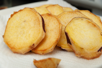 Brazilian cuisine - Close-up of delicious homemade sweet potatoes on paper towels. Horizontal shot.
