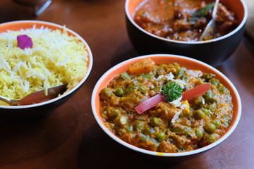 close up vegetable curry and rice in bowl on table. traditional Indian food. blur background