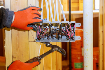Work on installing electrical outlets mounts in new home