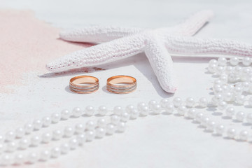 Wedding rings close up decorated nautical with accessories for tropical caribbean outdoor wedding ceremony on the sandy beach in Dominican republic, Punta Cana