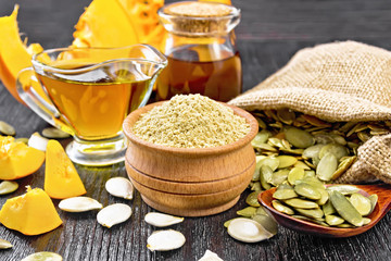 Flour pumpkin in bowl with oil on black board