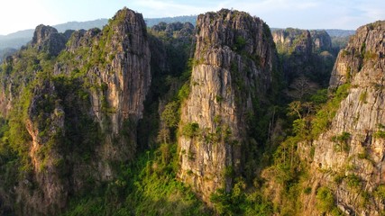 Rock mountain hills peak at sunrise with beautiful Rock in morning light. Thailand National Park , Aerial Drone Flight top down View.	