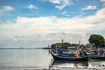 Fishing boats on the shore at low tide . Thailand