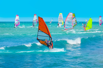 Beautiful cloudy sky with Windsurfer Surfing The Wind On Waves In Alacati - Cesme, Turkey