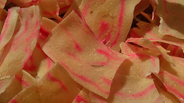 Raw cassava chips. Indonesia (Javanese) called it as opak telo. Traditional chips made off cassava. The taste is crunchy, savory, tasteful and delicious.