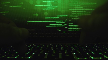 Cyber hacker attack data secure in spy typing on laptop keyboard