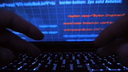 Cyber hacker attack data secure in spy typing on laptop keyboard