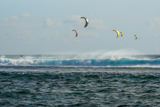 Colorful kites against a background of huge waves of the Indian Ocean. Mauritius Island