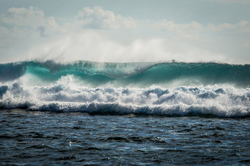 A huge wave for surfing . The photo was taken from the water in the Indian Ocean island of Mauritius