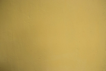 Bright yellow painted wall, blank background and texture, paint on a concrete 