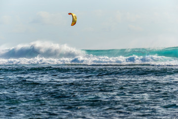 Kiter rides big waves on the island of Mauritius, Indian Ocean