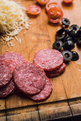 Making pepperoni pizza, raw ingredients. Selective focus. Shallow depth of field.