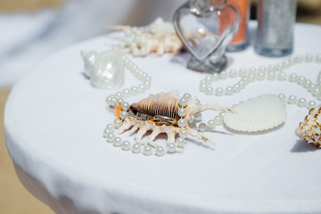 Wedding rings close up decorated nautical with accessories for tropical caribbean outdoor wedding ceremony on the sandy beach in Dominican republic, Punta Cana
