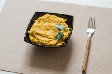 Making hummus and tahini at home. Black ceramic plate