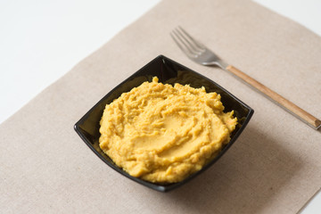 Making hummus and tahini at home. Black ceramic plate