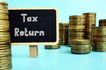 Business concept meaning Tax Return with sign on the sheet.