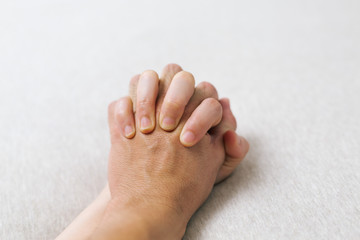 Hands of couple lovers having sex on a bed.