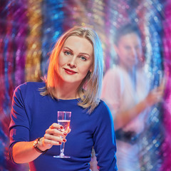 Excited happy woman holding glass with sparkling wine