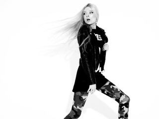 Young beautiful hipster girl in black leather jacket and stylish fashionable tight military pants...